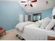 Bright primary bedroom featuring plush bedding, a ceiling fan, and ample natural light at 11911 Brownestone View Dr, Charlotte, NC 28269