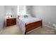 Bedroom featuring plush bedding, a wooden bed frame, and natural light at 11911 Brownestone View Dr, Charlotte, NC 28269