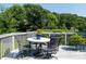 Outdoor deck features a table with seating, a potted plant, and a view of the backyard at 11911 Brownestone View Dr, Charlotte, NC 28269