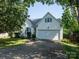 Charming home featuring white siding, blue shutters, and a two-car garage at 11911 Brownestone View Dr, Charlotte, NC 28269
