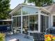 Exterior view of the sunroom and deck shows the access to the backyard and surrounding trees at 11911 Brownestone View Dr, Charlotte, NC 28269