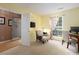 Bright home office with a computer setup, cozy chair, and ample natural light at 11911 Brownestone View Dr, Charlotte, NC 28269