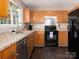 Well-lit kitchen boasting stainless steel appliances, wood cabinets, and granite countertops at 11911 Brownestone View Dr, Charlotte, NC 28269