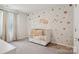 Bedroom with a crib and soft, decorative touches creates a cozy and inviting space at 120 Parson Ln, Statesville, NC 28625