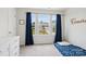 Bright bedroom featuring three windows with blue curtains and plush carpet flooring at 120 Parson Ln, Statesville, NC 28625