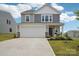 Charming two-story home featuring gray siding, a two-car garage, landscaped front yard, and a welcoming front porch at 120 Parson Ln, Statesville, NC 28625