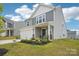 Charming two-story home featuring gray siding, a two-car garage, landscaped front yard, and a welcoming front porch at 120 Parson Ln, Statesville, NC 28625