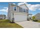 Two-story home featuring gray siding, a two-car garage, and a well-maintained lawn at 120 Parson Ln, Statesville, NC 28625