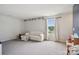 Carpeted living room with white sofa, pencil-themed decor, and natural light from a large window at 120 Parson Ln, Statesville, NC 28625