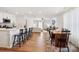 Open concept living area with hardwood floors, an island with seating, and a dining table at 120 Parson Ln, Statesville, NC 28625