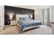 Comfortable main bedroom with a decorative accent wall, large window, and soft carpet flooring at 120 Parson Ln, Statesville, NC 28625