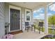 Inviting front porch with seating, a decorative wreath on the front door, and manicured landscaping at 120 Parson Ln, Statesville, NC 28625