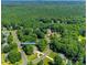 Aerial view of a home nestled in a lush, green neighborhood with mature trees and winding roads at 125 Highland Forest Dr, Clover, SC 29710