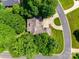 Aerial view of the home showcasing lush, mature landscaping, a circular driveway, and a well-maintained roof and property at 125 Highland Forest Dr, Clover, SC 29710