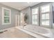 Bathroom features a large tub with jets, white tile, and a glass enclosed shower at 125 Highland Forest Dr, Clover, SC 29710