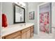 Bright bathroom featuring a vanity with a large mirror and a separate shower area with a floral curtain at 125 Highland Forest Dr, Clover, SC 29710