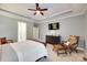 Bedroom features neutral carpet, blue-grey walls, and a large dark wood dresser with TV at 125 Highland Forest Dr, Clover, SC 29710