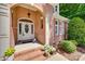 Close-up of a brick home's front entrance with flower pots, sidelights, and an arched entryway at 125 Highland Forest Dr, Clover, SC 29710