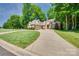 Traditional brick home featuring a two-car garage and a manicured lawn at 125 Highland Forest Dr, Clover, SC 29710