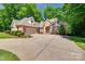 Traditional brick home featuring a two-car garage and a manicured lawn at 125 Highland Forest Dr, Clover, SC 29710