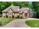 Beautiful brick home with manicured lawn and a curved driveway leading to the front entrance at 125 Highland Forest Dr, Clover, SC 29710