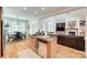 Open-concept kitchen seamlessly connecting to living room and dining area with hardwood floors and lots of counter space at 125 Highland Forest Dr, Clover, SC 29710
