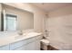 Bright bathroom featuring a white vanity, large mirror, and a tub with a shower at 136 Dorian Pl, Troutman, NC 28166