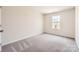 Cozy bedroom featuring plush carpeting, natural light, and ample space for a comfortable living experience at 136 Dorian Pl, Troutman, NC 28166
