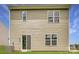 Rear exterior of home with sliding glass door onto grass and window views at 136 Dorian Pl, Troutman, NC 28166