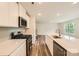 Modern kitchen featuring white cabinets, stainless steel appliances, and a stylish island perfect for cooking at 136 Dorian Pl, Troutman, NC 28166