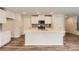 Bright kitchen with white cabinets, center island, stainless appliances and hardwood flooring at 136 Dorian Pl, Troutman, NC 28166