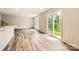 Open-concept living room featuring hardwood floors, bright windows, and sliding glass doors for seamless indoor-outdoor living at 136 Dorian Pl, Troutman, NC 28166