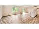 Spacious living room featuring hardwood floors, abundant natural light, and seamless access to the outdoors at 136 Dorian Pl, Troutman, NC 28166