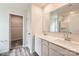 Elegant bathroom featuring a dual sink vanity, large mirror, and glass-enclosed shower with stylish fixtures at 136 Dorian Pl, Troutman, NC 28166