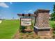Winecoff Village entrance sign with brick pillar, landscaping, and lush green grass at 136 Dorian Pl, Troutman, NC 28166