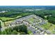 Overhead view of a charming neighborhood features lush trees, winding roads, and well-maintained homes with manicured lawns at 139 Suggs Mill Dr, Mooresville, NC 28115