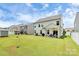 Spacious backyard with lush green grass, features a patio, shed, and privacy fence, ideal for outdoor activities at 139 Suggs Mill Dr, Mooresville, NC 28115