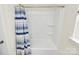 Clean white shower and tub combination with blue and white striped shower curtain at 139 Suggs Mill Dr, Mooresville, NC 28115