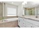Well-lit bathroom featuring granite counters, soaking tub, and a glass shower at 139 Suggs Mill Dr, Mooresville, NC 28115