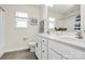 Bright bathroom featuring a double vanity with white cabinets, tile floors, and natural light at 139 Suggs Mill Dr, Mooresville, NC 28115
