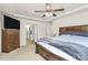 Bright bedroom featuring tray ceilings, ceiling fan, and direct bath access at 139 Suggs Mill Dr, Mooresville, NC 28115