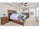 Bright bedroom featuring tray ceilings, ceiling fan, and many windows at 139 Suggs Mill Dr, Mooresville, NC 28115