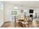 Bright dining area with slider door to patio, wood-look floors, and modern chandelier at 139 Suggs Mill Dr, Mooresville, NC 28115
