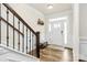 Welcoming foyer with hardwood floors, a staircase, and a bright white door, creating a pleasant entrance at 139 Suggs Mill Dr, Mooresville, NC 28115