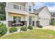 Charming front porch with rocking chairs, stone accents, and landscaped greenery, inviting relaxation and curb appeal at 139 Suggs Mill Dr, Mooresville, NC 28115