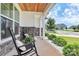 Cozy front porch featuring rocking chairs, complemented by lush greenery and a view of the neighborhood street at 139 Suggs Mill Dr, Mooresville, NC 28115