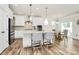 Modern white kitchen with stainless steel appliances, a central island, and a breakfast nook with natural light at 139 Suggs Mill Dr, Mooresville, NC 28115