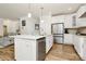 Spacious kitchen featuring stainless steel appliances, a granite island, and ample cabinet space, perfect for cooking and entertaining at 139 Suggs Mill Dr, Mooresville, NC 28115