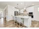Contemporary kitchen with white cabinetry, granite countertops, and stainless steel appliances, blending style and functionality at 139 Suggs Mill Dr, Mooresville, NC 28115