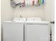 Well-lit laundry room featuring a modern, front-loading washer and dryer at 139 Suggs Mill Dr, Mooresville, NC 28115